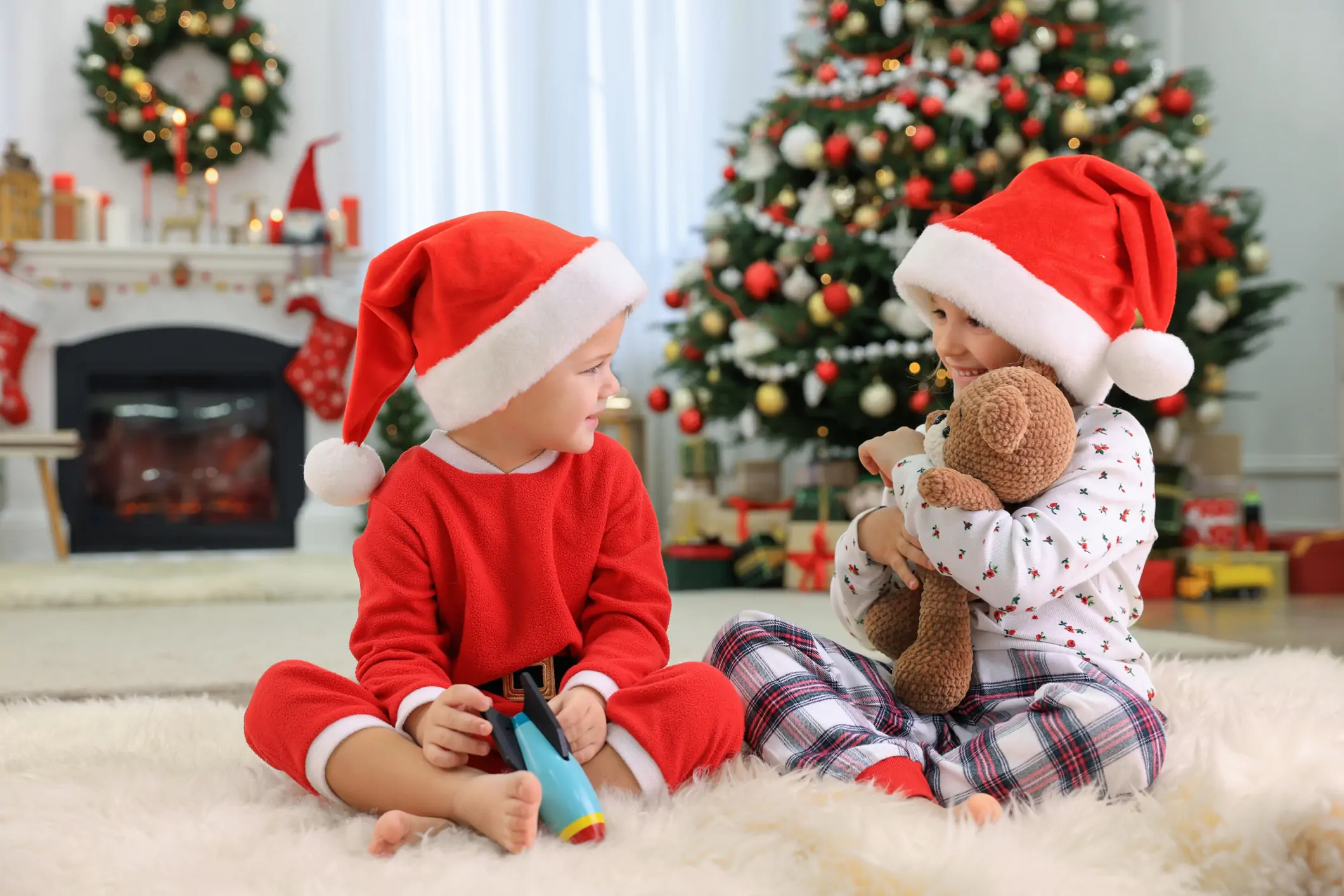 Two kids opening presents.