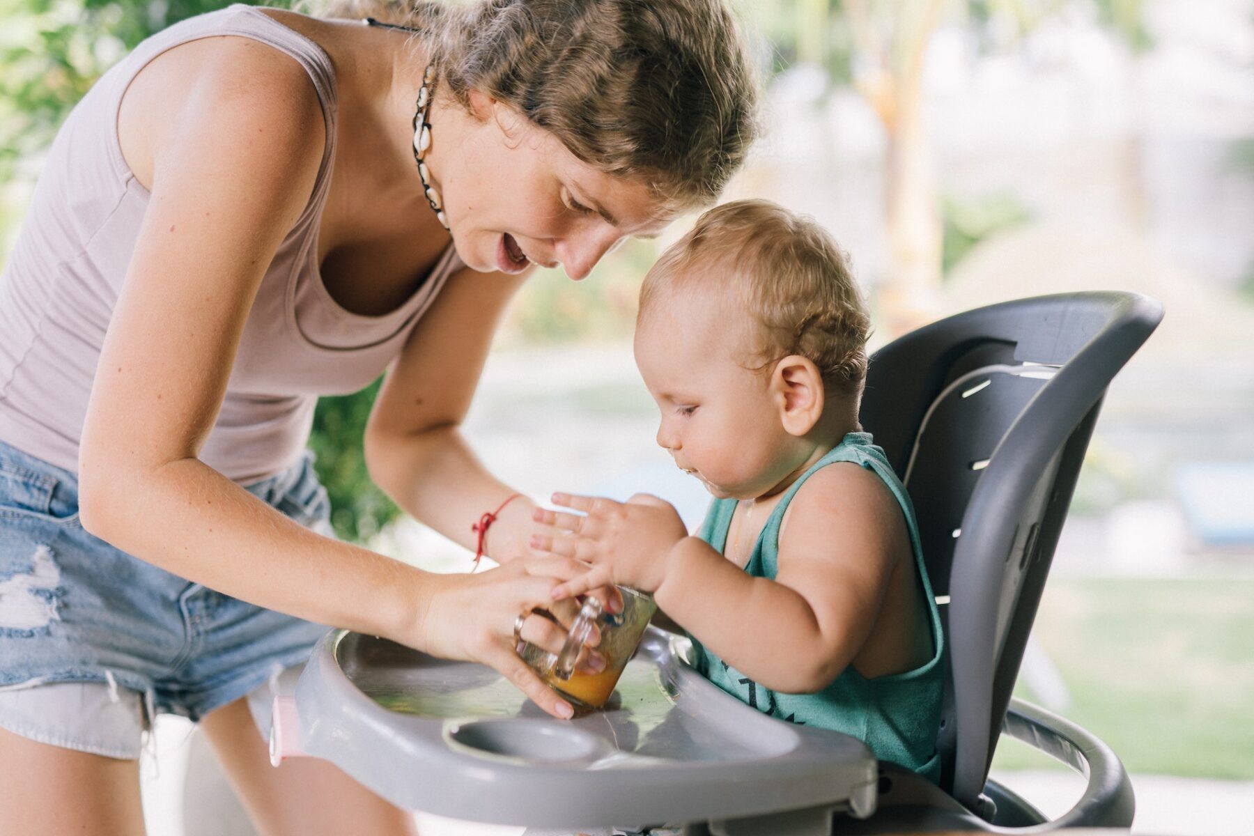 Baby in highchair eating.