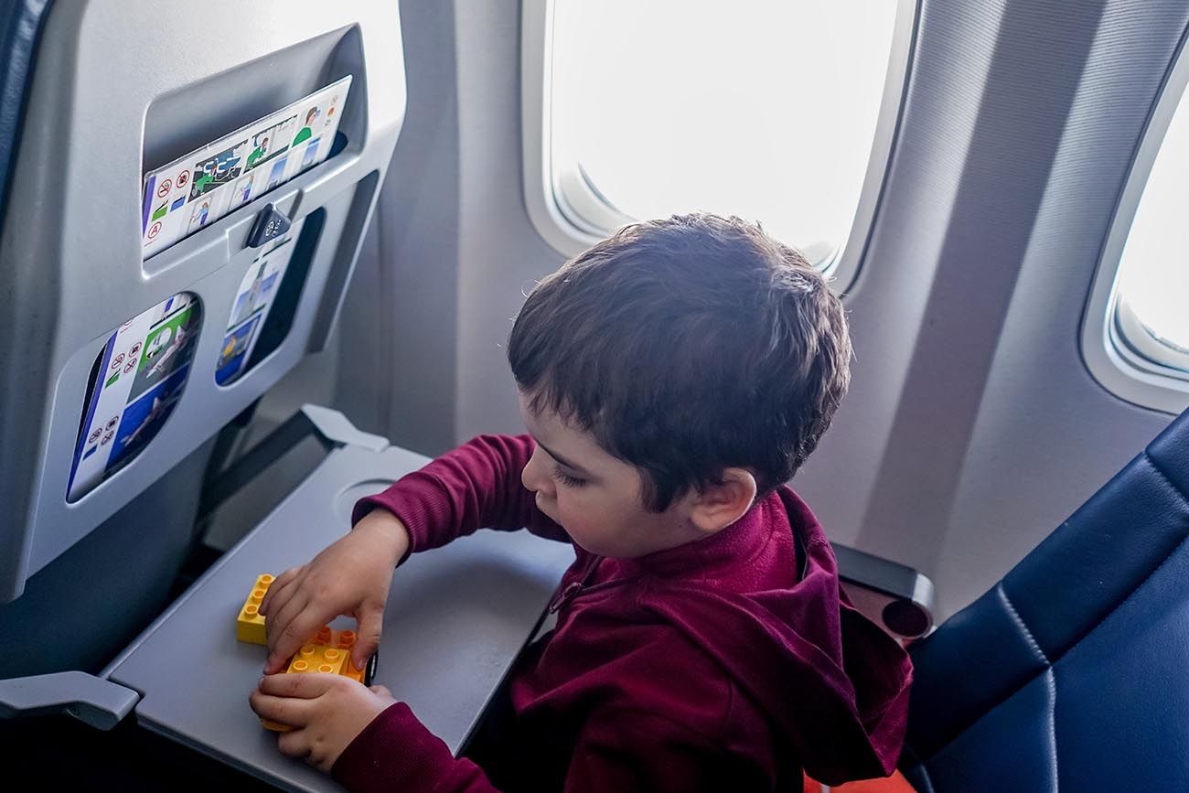 boy playing with lego on the plane