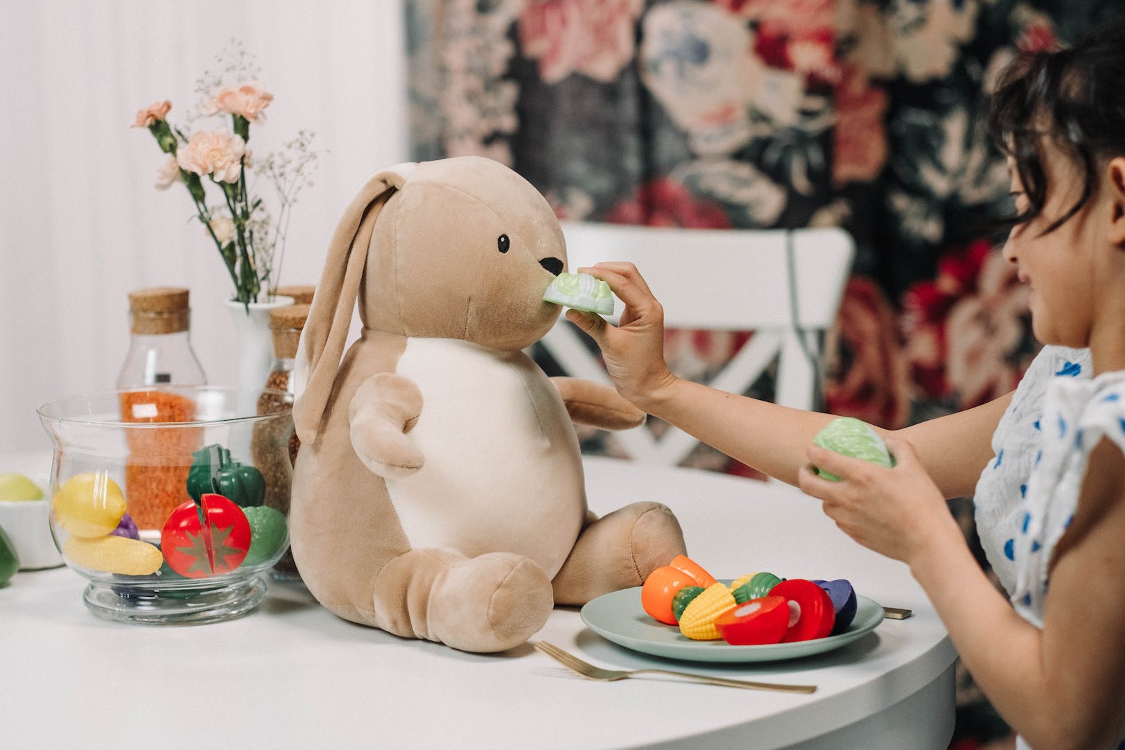 Child playing with teddy.