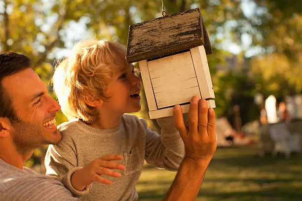 child with birdfeeder