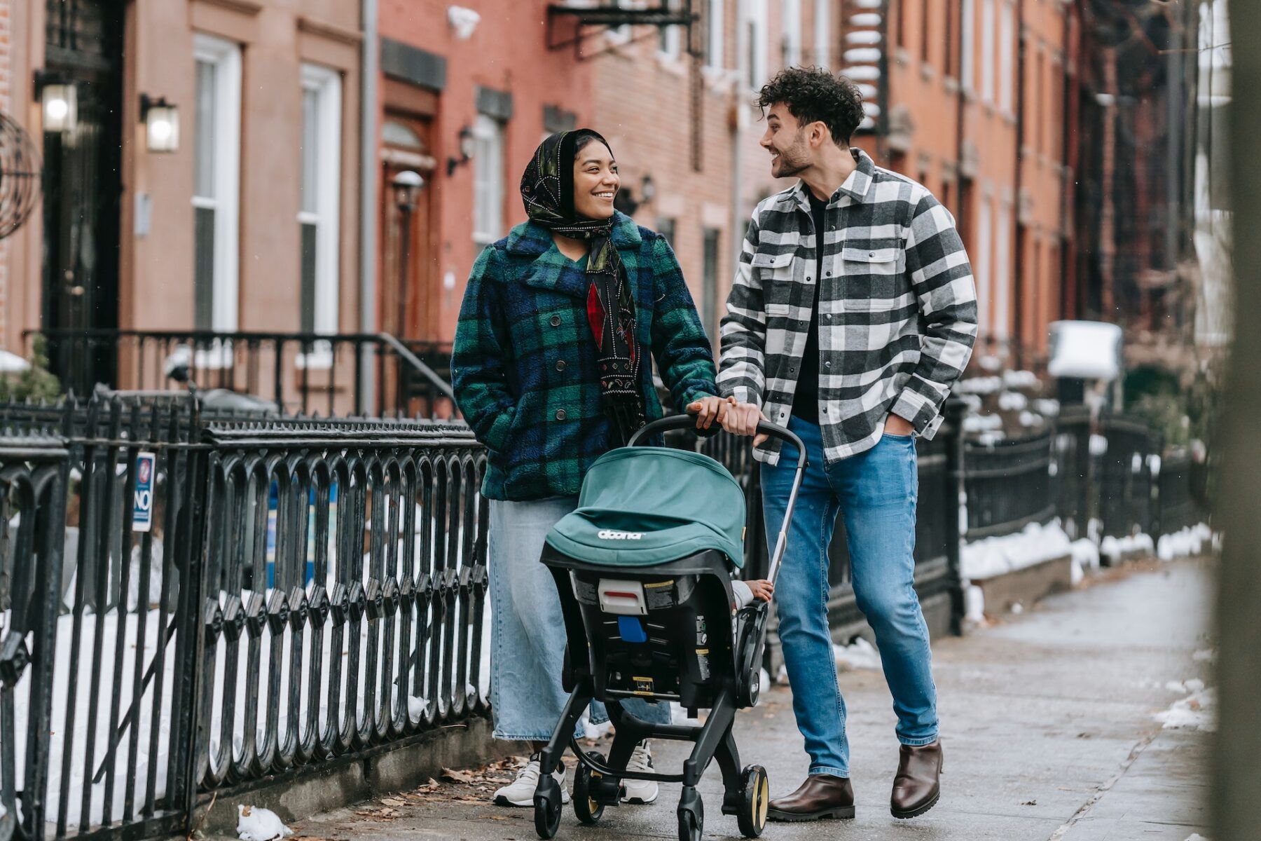 Family walking with pushchair.