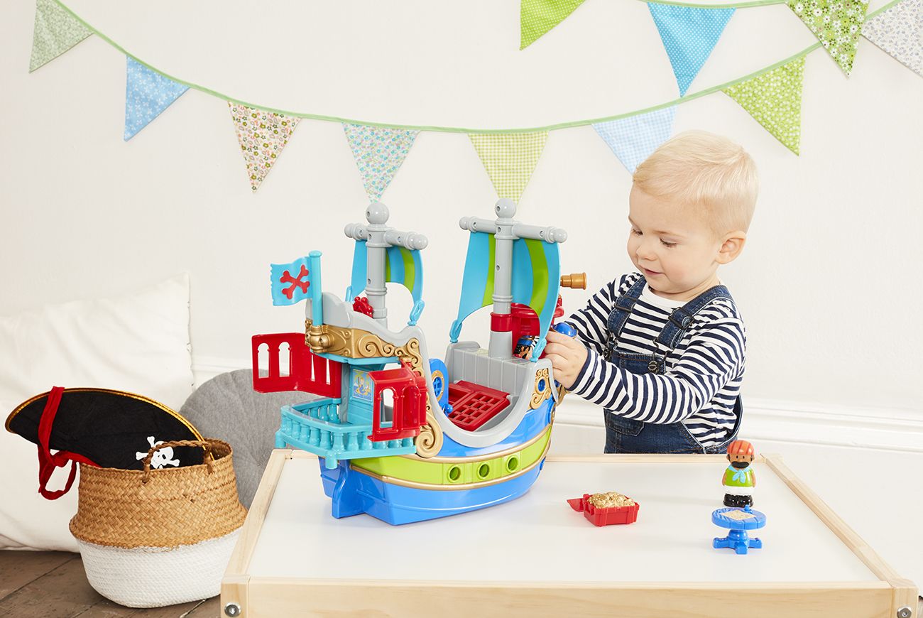 Little boy plays with the product Happyland Pirate Set.