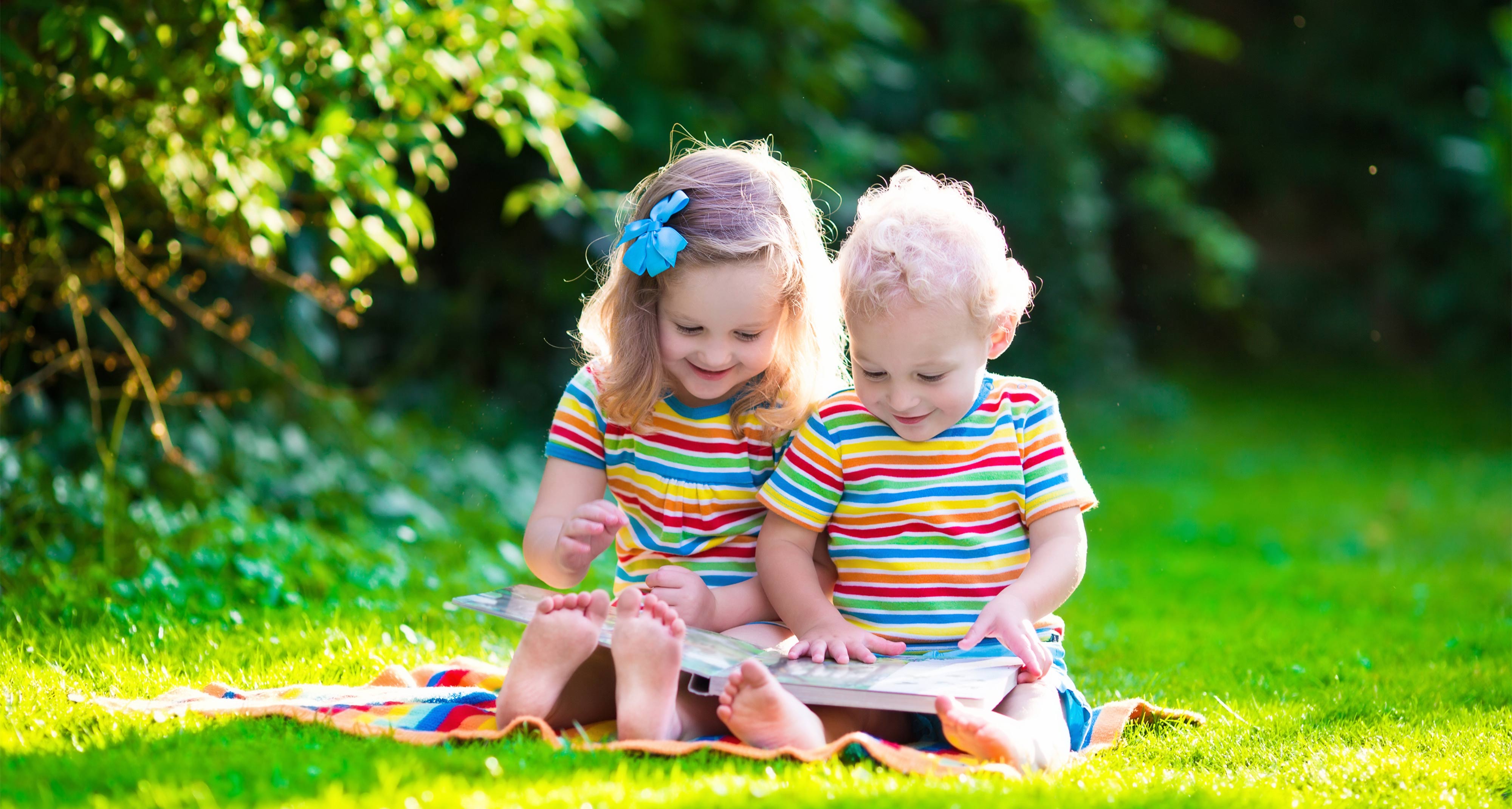 The Importance Of Child Literacy - two small children reading a book