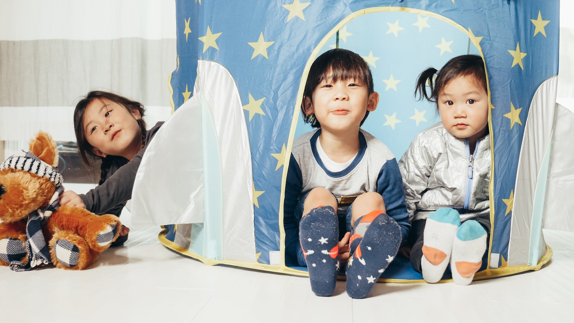 Kids sitting in a tent.