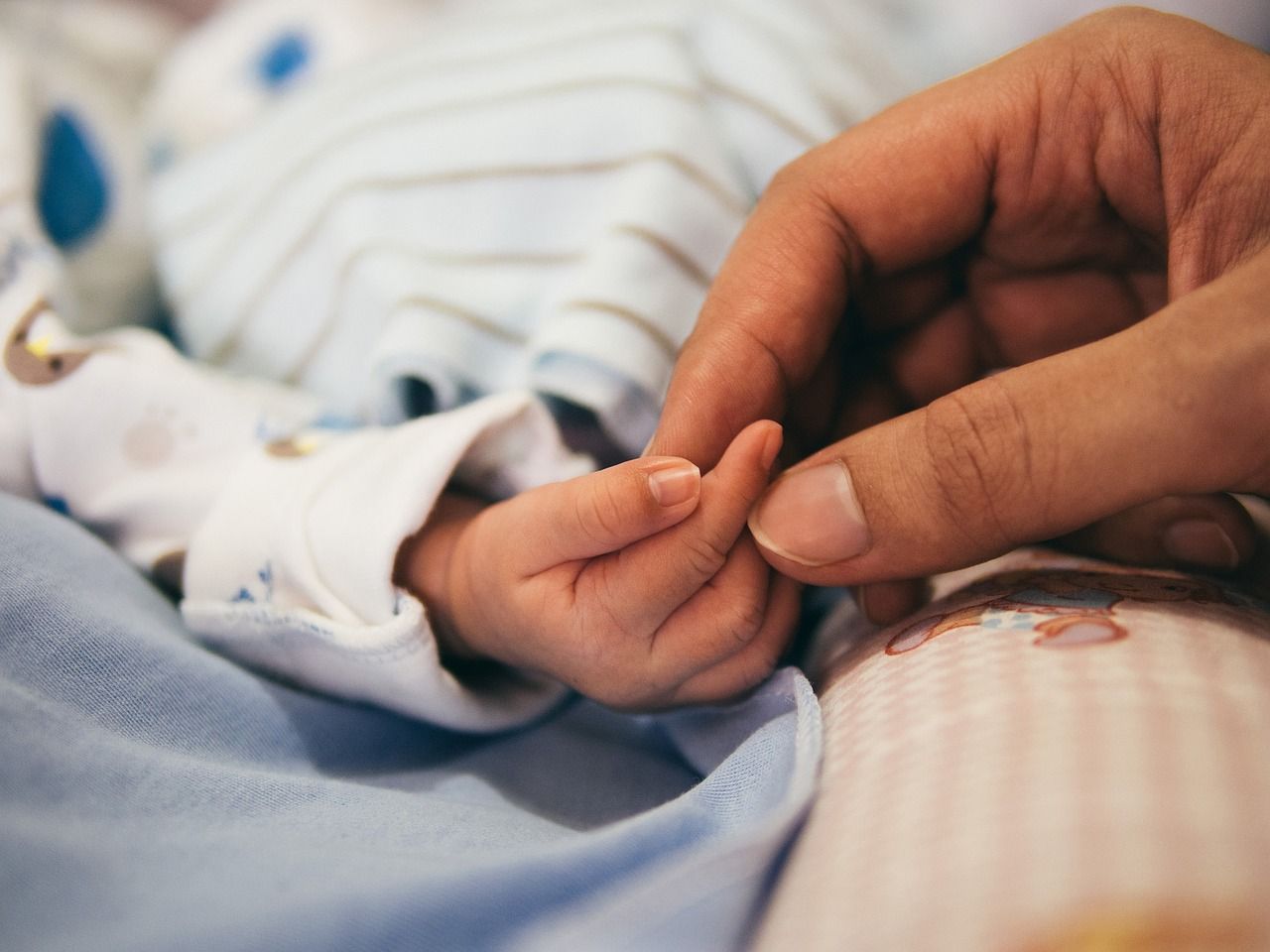 newborn and mum hand