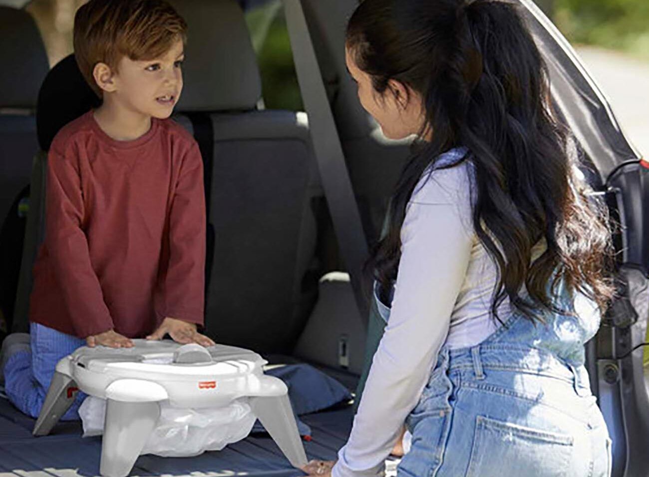 Mum and son with travel potty.