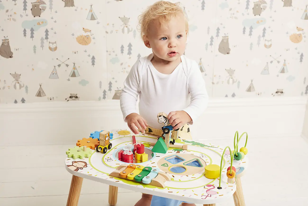 Baby plays with wooden toy.