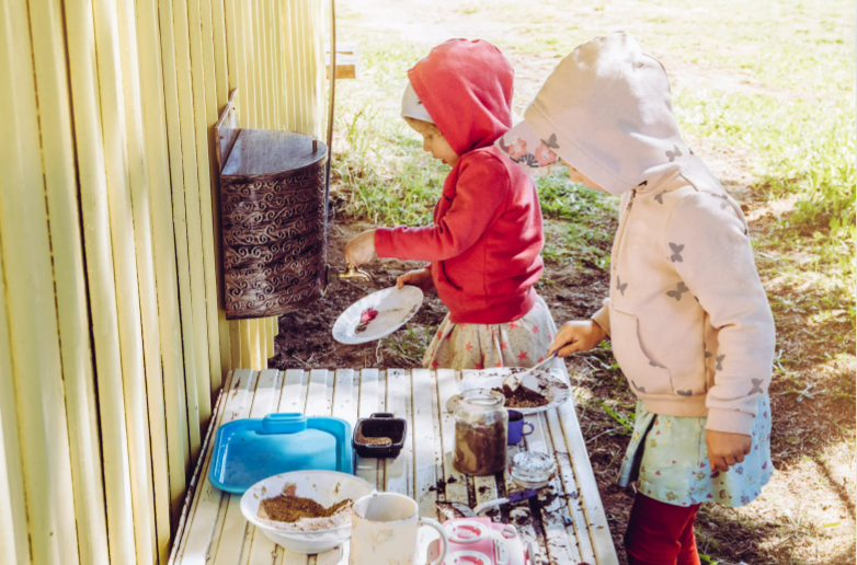 Kids playing with a mud kitchen.