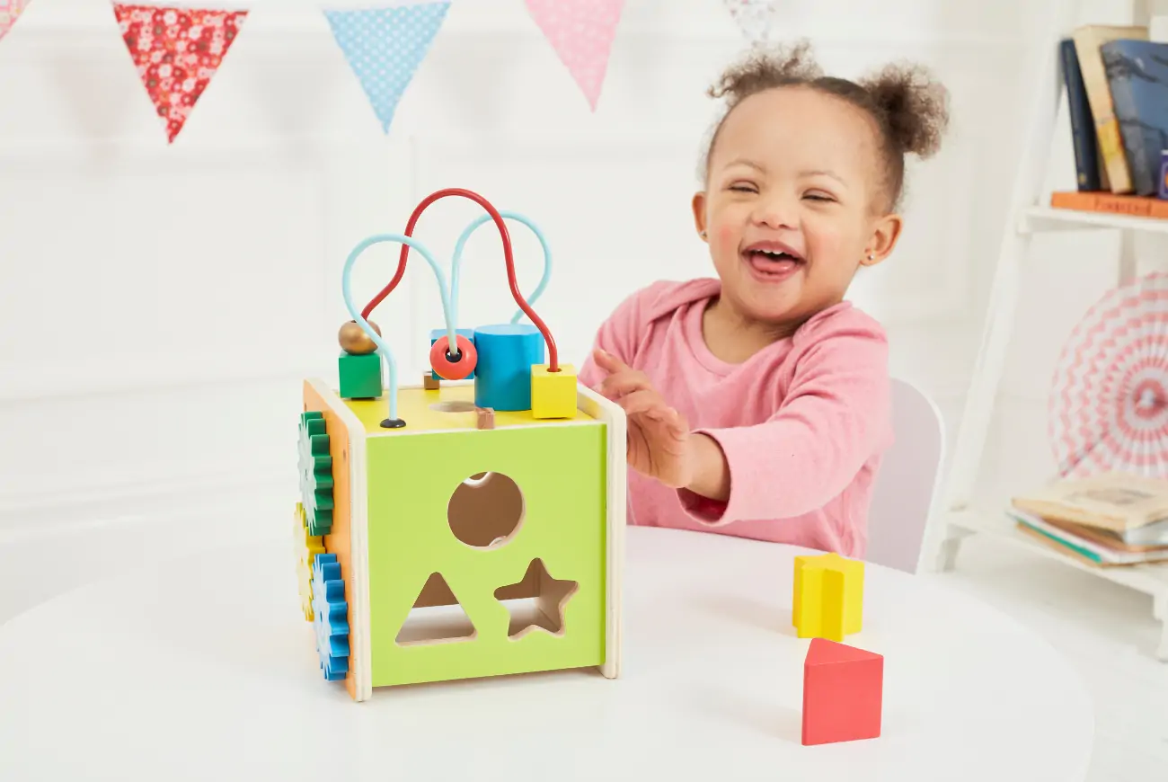 Girl playing with puzzle activity toy