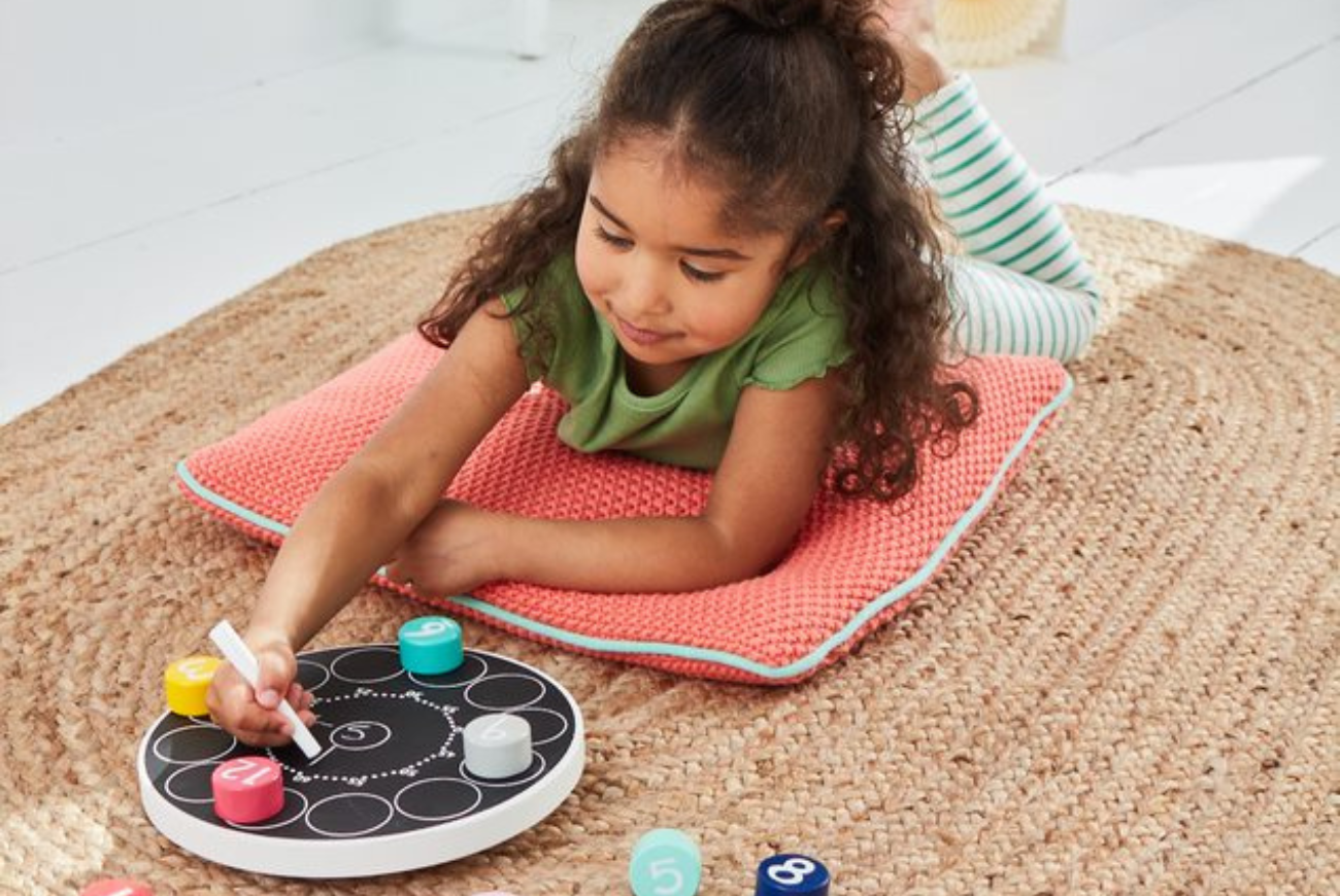 GIrl playing with clock puzzle